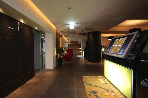 a hallway with a tv in a room at HOTEL W-PREMIUM -W GROUP HOTELS and RESORTS- in Koshigaya