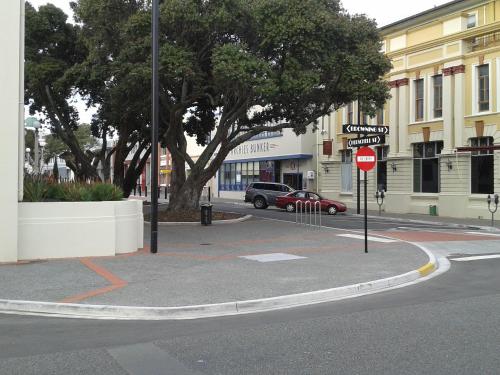 a street corner with a stop sign and a tree at Archies Bunker Affordable Accommodation in Napier