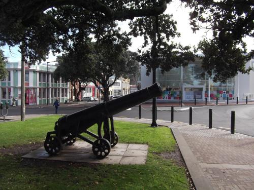 a cannon sitting on the grass near a street at Archies Bunker Affordable Accommodation in Napier