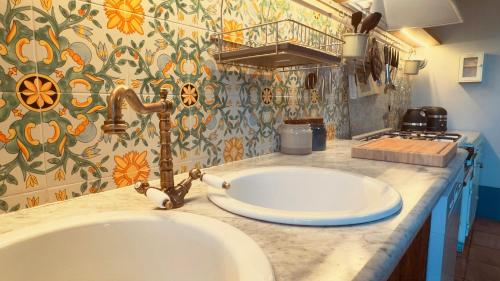 a bathroom with a sink and aaucet on a counter at Pool Villa With Animals Near Sutri in Sutri