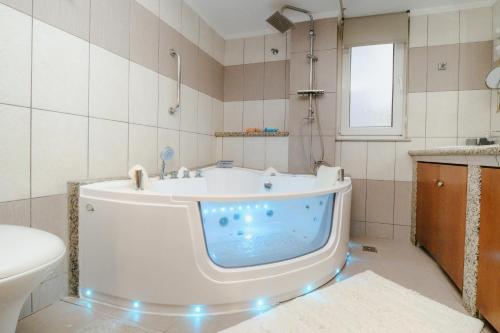 a bathroom with a tub in the middle of it at Sunny home crete in Ierapetra