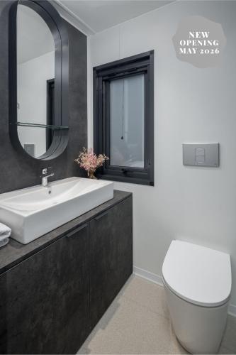 a bathroom with a sink and a toilet and a mirror at Boutique Camping Materada Beach in Poreč