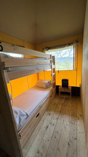 a bunk bed in a small room with a window at Gran Camping Zarautz in Zarautz