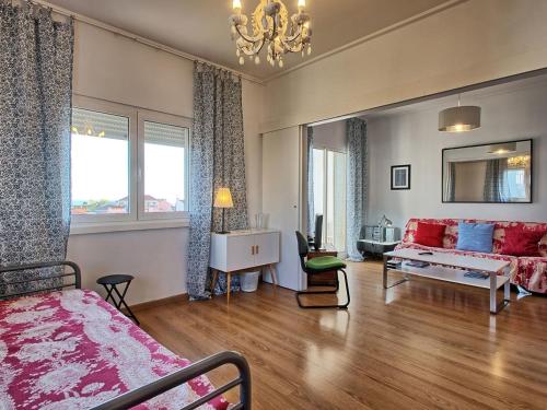 a bedroom with a bed and a living room at Apartment Wunderschöner Paço D'Arcos by Interhome in Paço de Arcos