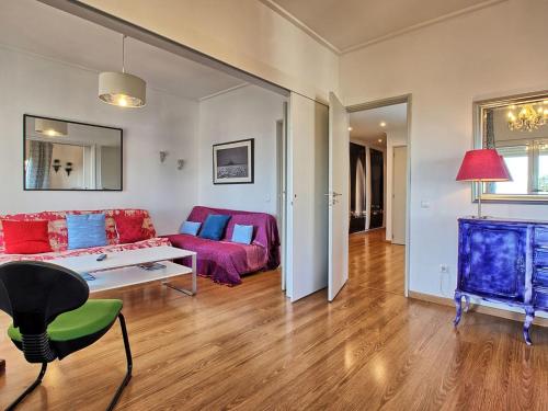 a living room with a couch and a table at Apartment Wunderschöner Paço D'Arcos by Interhome in Paço de Arcos