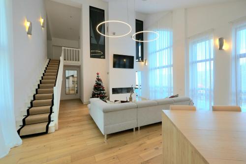 a living room with a couch and a christmas tree at The Rock in Sinaia