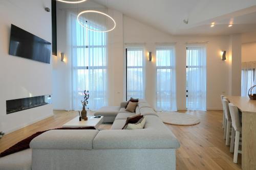 a living room with a large couch and a table at The Rock in Sinaia