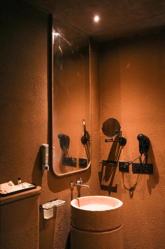 a bathroom with a sink and a mirror at Ayana Villa By KPM in Varagampadi