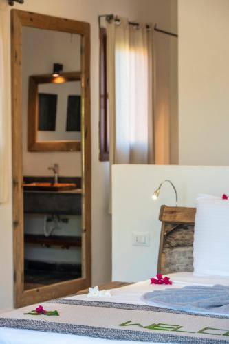 a bedroom with a bed with a mirror and a sink at Di Milo Boutique Hotel in Kiwengwa