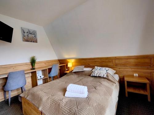 En eller flere senge i et værelse på Ośrodek Wypoczynkowy Baca