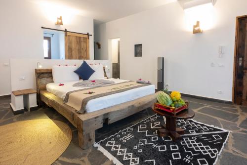 a bedroom with a large bed in a room at Di Milo Boutique Hotel in Kiwengwa