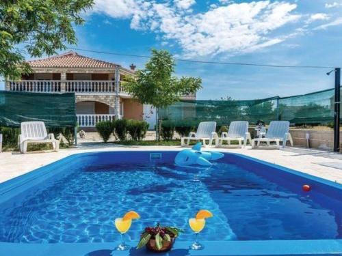a swimming pool with a toy duck in the water at Apartment Laura mit Pool by Interhome in Stankovci