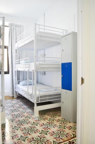 a room with two bunk beds in a room at La Isleta Nest Hostel in Las Palmas de Gran Canaria