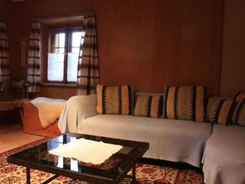 a living room with a couch and a coffee table at Apartment Davo Tuoi by Interhome in Guarda