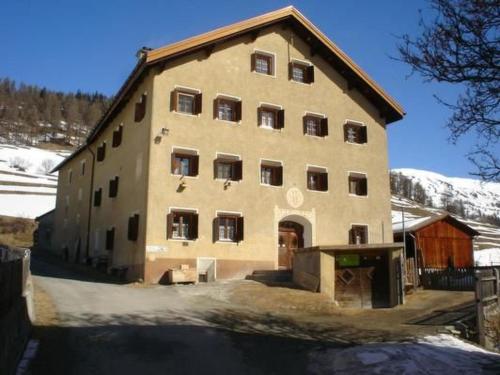 a large building with a lot of windows in the snow at Apartment Davo Tuoi by Interhome in Guarda