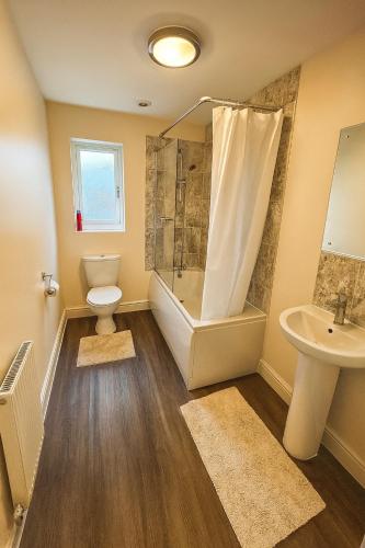 a bathroom with a toilet and a shower and a sink at Cosy House with Garden, 2 Bedrooms in Doncaster