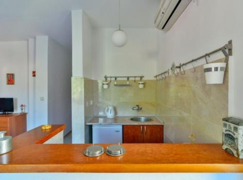 a kitchen with a wooden counter and a sink at Villa Marković 2 in Sutomore
