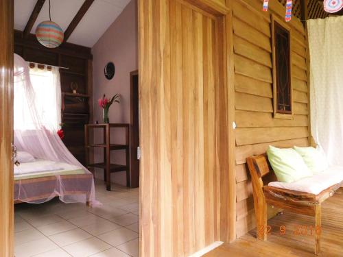 a room with a bedroom with a bed and a door at Casa Lina EcoLodge privat apartment in Puerto Viejo