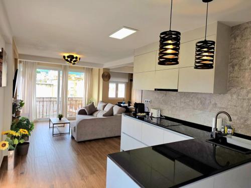 a kitchen and living room with a couch at Infinity Torremolinos Spacious 2 Bedroom, 2 Bathroom Apartment by NAMASTE ELITE in Torremolinos
