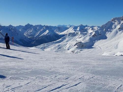 a person is skiing down a snow covered mountain at Apartment cajos-ftan by Interhome in Ftan
