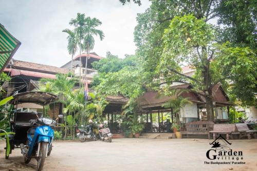 a blue motorcycle parked in front of a building at Garden Village Guesthouse & Pool Bar in Siem Reap