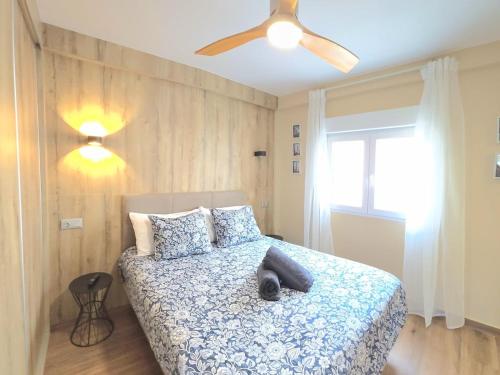 a bedroom with a bed with a ceiling fan at Infinity Torremolinos Spacious 2 Bedroom, 2 Bathroom Apartment by NAMASTE ELITE in Torremolinos