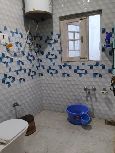 a bathroom with blue stars on the wall and a toilet at Gulmarg View Guest House in Khor