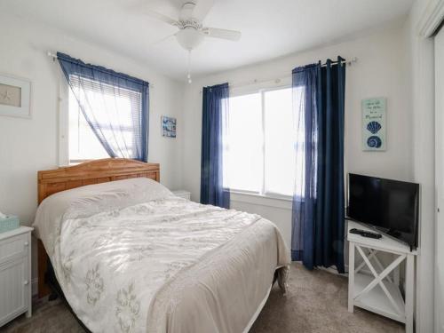 een slaapkamer met een bed en een flatscreen-tv bij Summer Escape In Loveladies Prime Long Beach Island Location in Loveladies