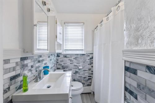 a white bathroom with a sink and a toilet at 308A E Heather Rd, #3081 in Wildwood Crest