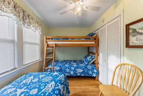 a bedroom with two bunk beds and a chair at 308A E Heather Rd, #3081 in Wildwood Crest