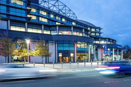 a large building with cars speeding by in front of it at Radisson RED London Twickenham in Twickenham