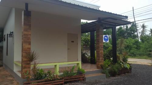 a building with a sign on the side of it at The House at Pranburi in Pran Buri