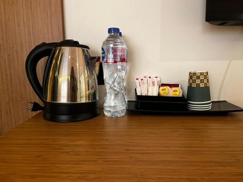 einen Wasserkocher und eine Flasche Wasser auf dem Tisch in der Unterkunft Nefertiti Royal Hotel in Kairo