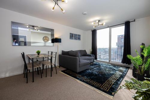 a living room with a couch and a table at Cityside Apartment Walk to Etihad & Coop Live in Manchester