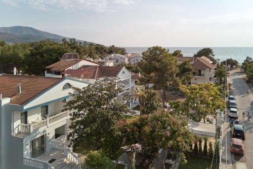 an aerial view of a city with houses and the ocean at Kazaviti Hotel in Prinos