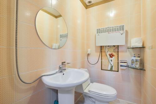 a bathroom with a sink and a toilet and a mirror at Heidi Korea in Hongcheon