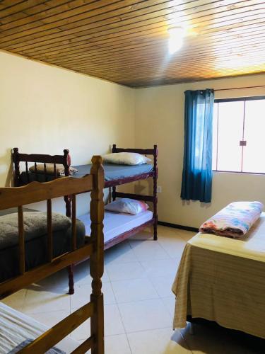 En eller flere senge i et værelse på Pousada Mizuyama