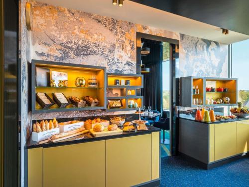 a bakery with bread and pastries on display at Sofitel Luxembourg Le Grand Ducal in Luxembourg