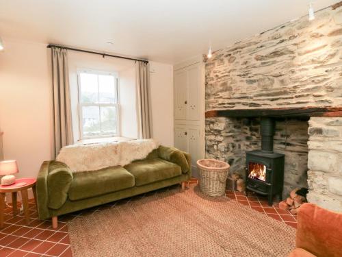 a living room with a couch and a fireplace at Fronglyd in Cardigan