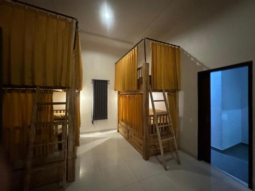 a room with two wooden cabinets and a ladder at Dream Beach Hostel Lembongan in Nusa Lembongan