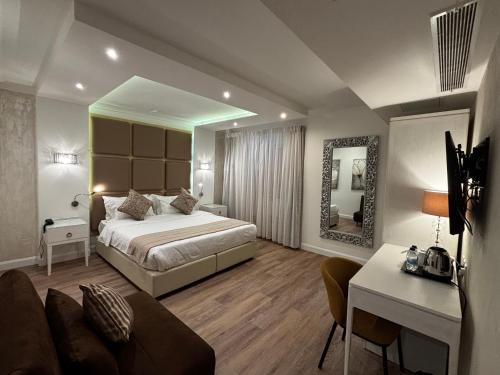 a hotel room with a bed and a mirror at Osborne Hotel in Valletta