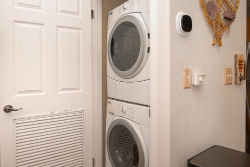 a washer and dryer in a kitchen next to a door at Waterside West A303 in Fraser