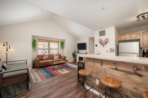 a kitchen with a counter and a living room at Waterside West A303 in Fraser