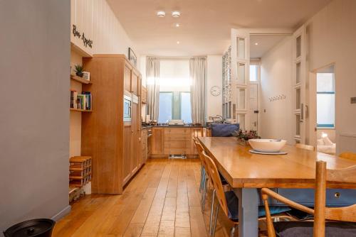 a kitchen and dining room with a wooden table at Main Street No 56 - Lower Largo in Lower Largo
