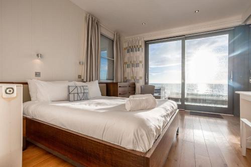a bedroom with a large bed with a large window at Main Street No 56 - Lower Largo in Lower Largo
