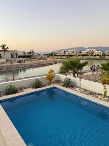 a swimming pool in the middle of a resort at Villa Laguna Lux TU10 in Salalah