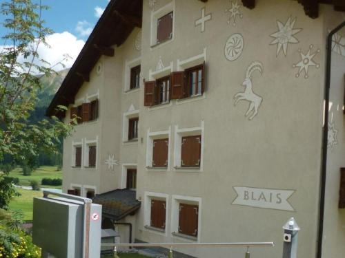 a building with drawings on the side of it at Apartment Chesa Blais by Interhome in Zuoz
