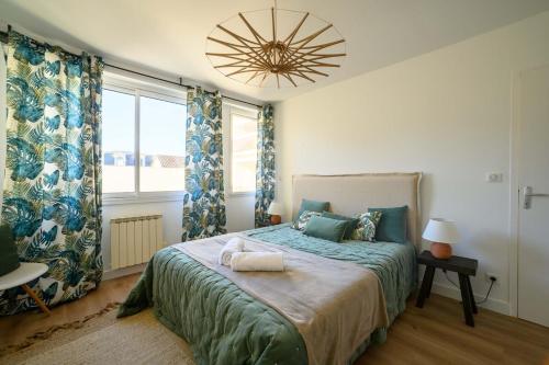 a bedroom with a bed and a large window at Le boudoir du Palais in Périgueux