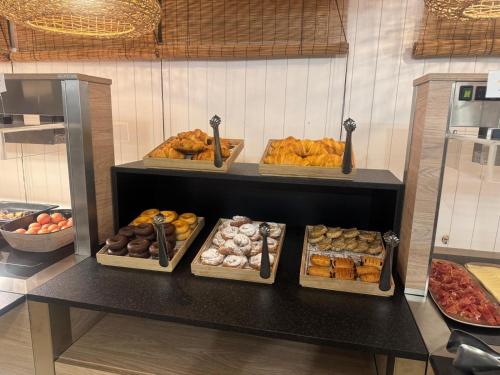 维耶拉维耶拉酒店 的架子上摆放着许多不同种类的甜甜圈。