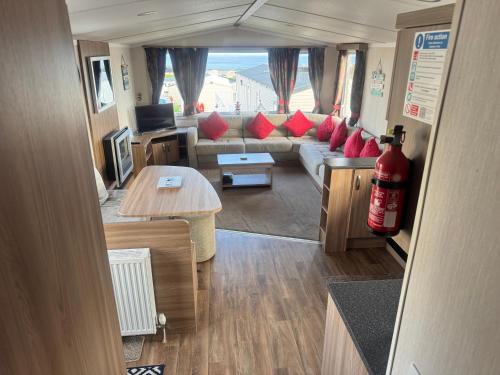 a living room with a couch and a table at The Pilot s Rest sleeps 6 in Exmouth